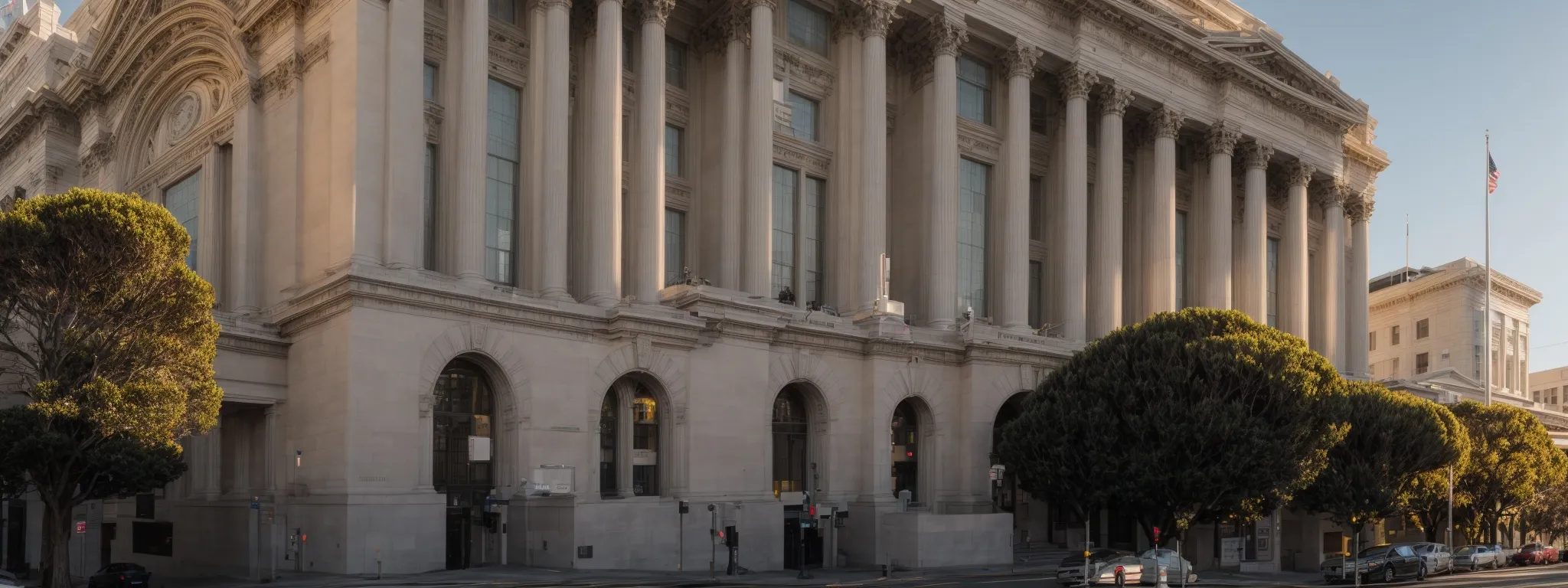 a panoramic view of a solemn san francisco courthouse façade reflecting the morning sun.